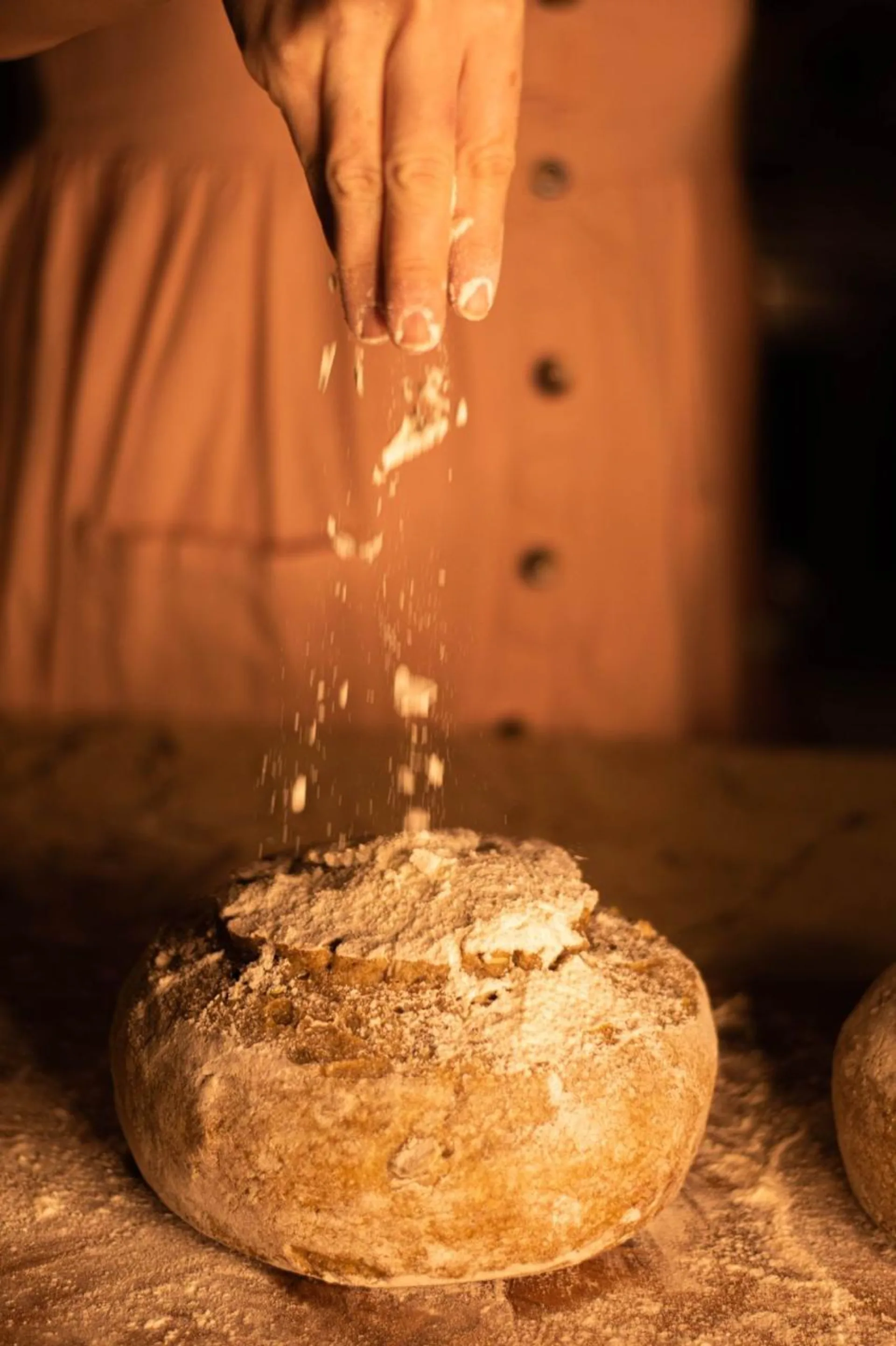 Enharinado artesanal de pan de masa madre recién horneado